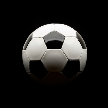 Soccer ball photographed against Black. 