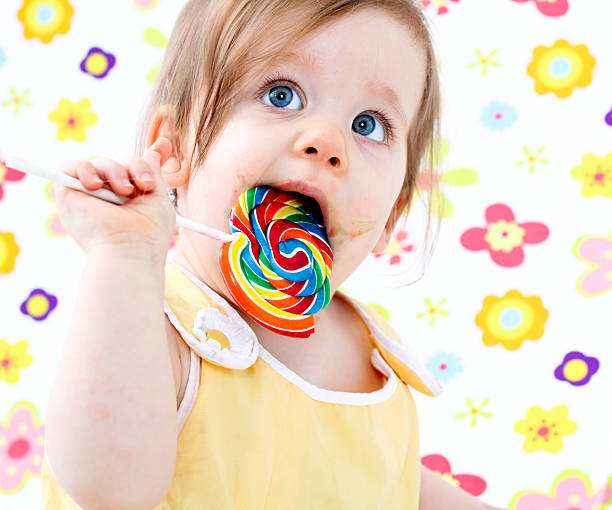 Cute baby with lollipop stock photo