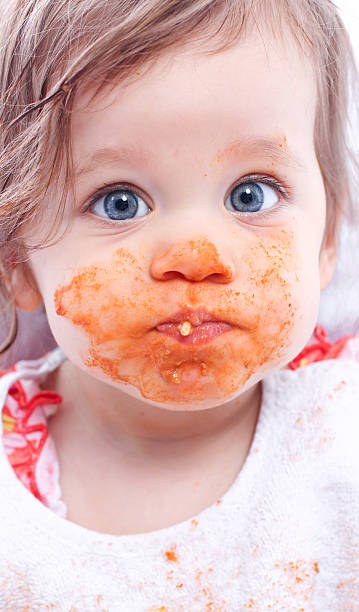 Baby eating spaghetti stock photo