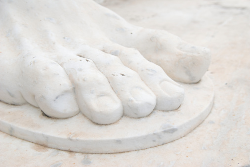 Close-up of massive marble toes and a simple sandal