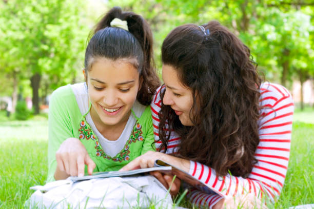 istock two cute friends studing in schoolyard 172923955