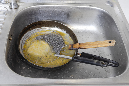 Wash the used pan and pour the old oil into the sink. Causing sinks and drains to become clogged.