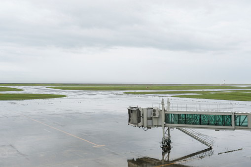 Rainy runway and boarding bridge