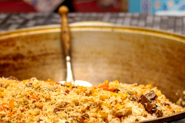 istock Uzbek pilaf in large cauldron close-up 1729243301