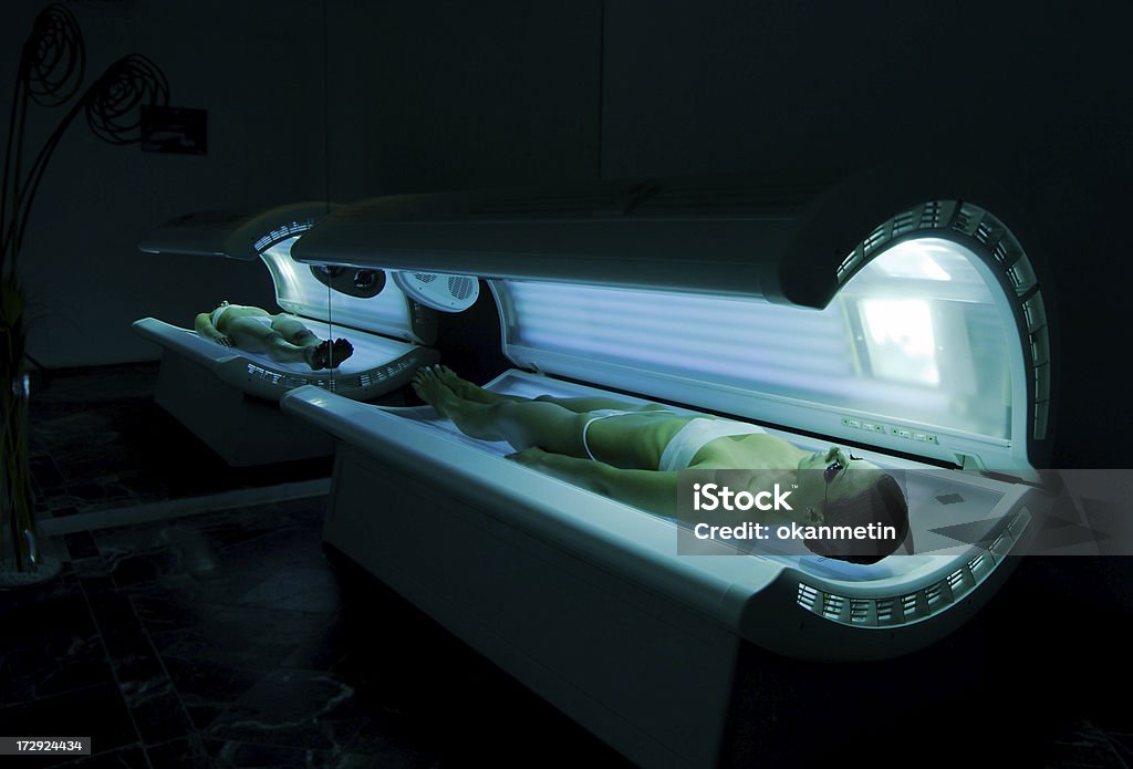 Tanning bed young women tanning in solarium Tanning Bed Stock Photo