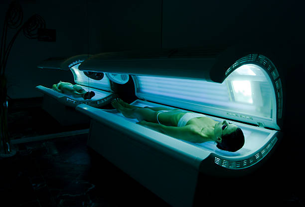 Tanning bed young women tanning in solarium tanning bed stock pictures, royalty-free photos & images