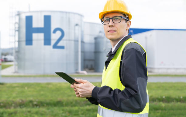 istock Engineer with digital tablet on a background of gas tanks 1729248521