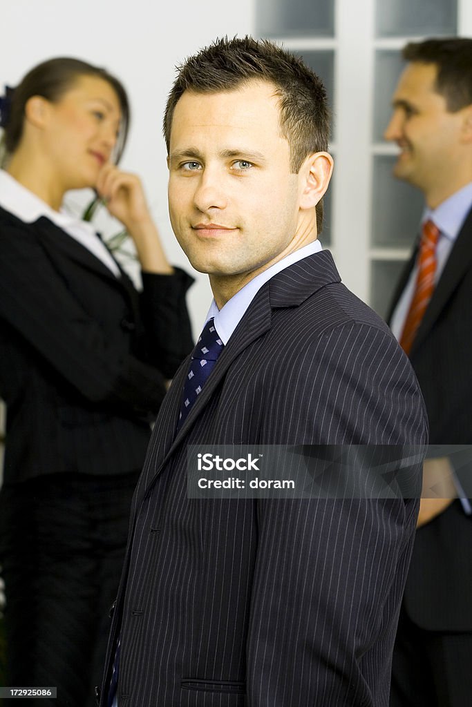 Leader standing in front of grupo - Foto de stock de Adulto joven libre de derechos