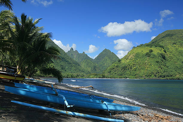 Tahitian view "Tahitian outrigger canoe, and mountain view." outrigger stock pictures, royalty-free photos & images