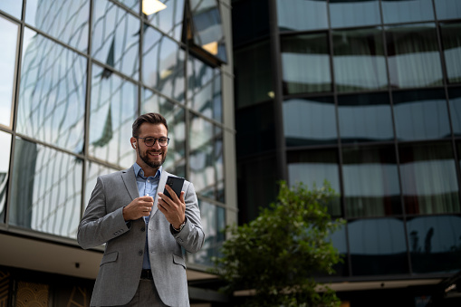 Business man using phone outdoors