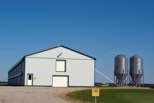 Poultry barn for chickens with Bio-Security signs posted to prevent diseases.