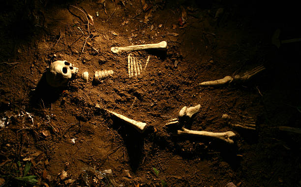Shallow grave of a skeleton.  Skeleton is faux.