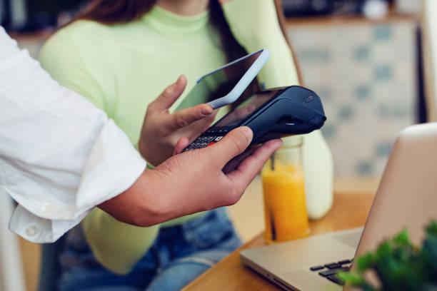 istock Young woman making card payment in cafeteria. 1729262960