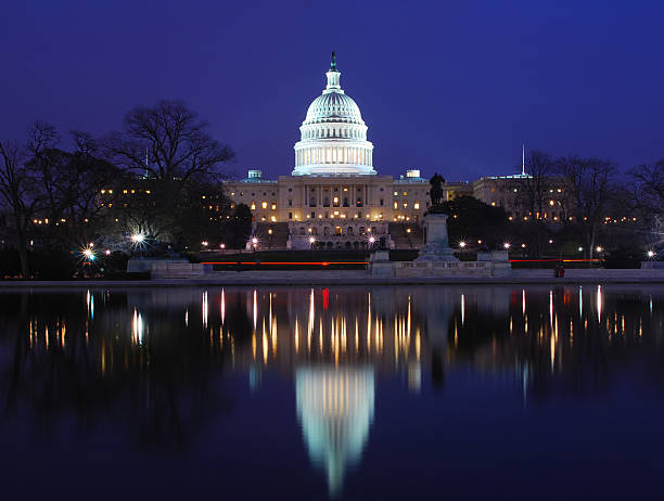 istock U.S. Capitol at night, with reflection in water 172926364
