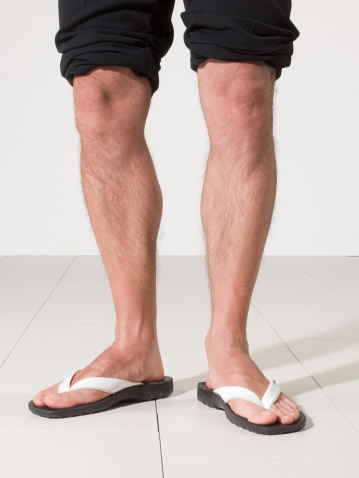 legs of a man with his flip-flop