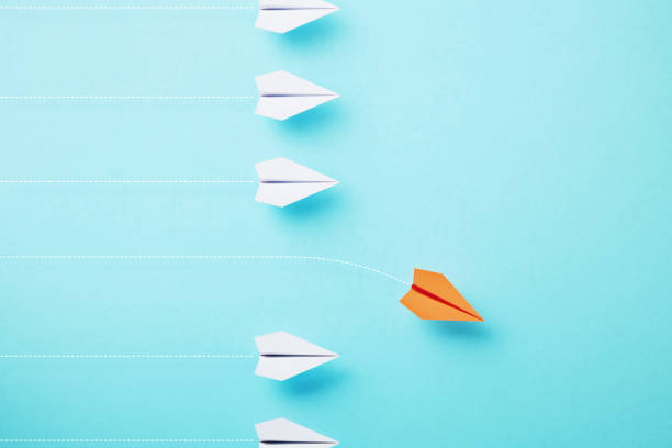 istock Paper Planes Flying On Different Directions On Blue Background 1729268319