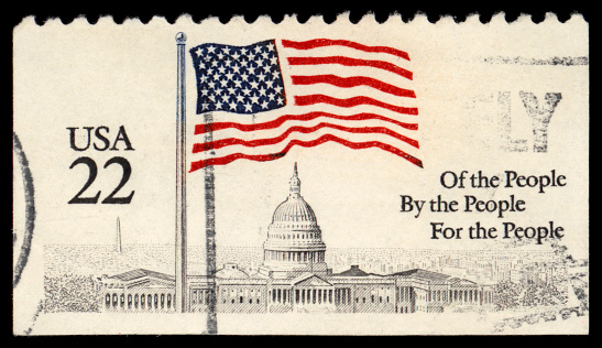 UNITED STATES OF AMERICA - CIRCA 1968: A used postage stamp printed in United States shows a waving USA flag on the coastal star-shaped fort McHenry on Baltimore Harbor, circa 1968