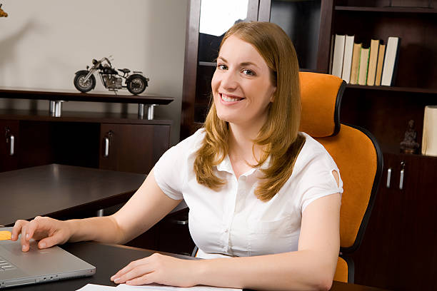 Woman happily working in the office stock photo