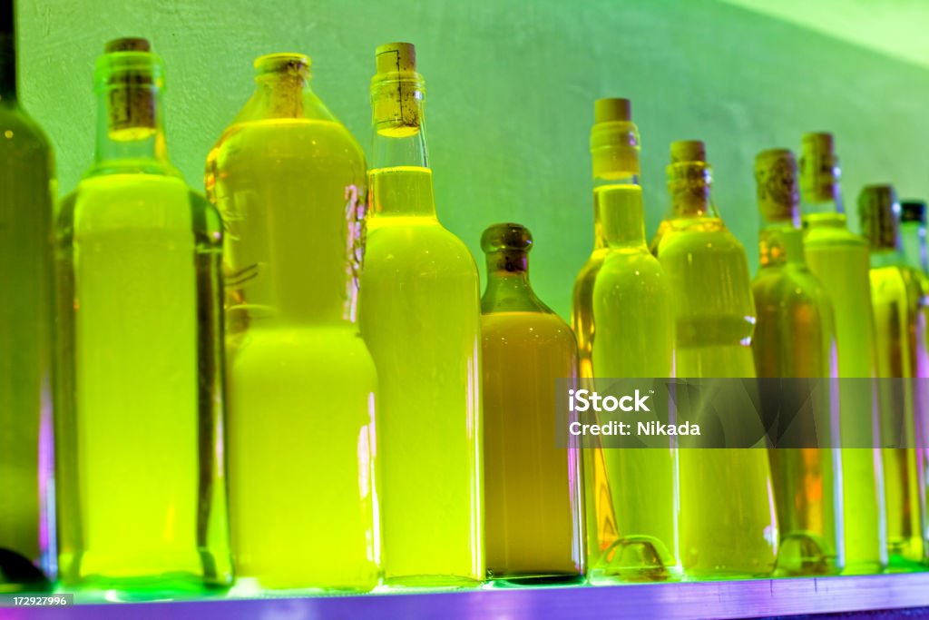 yellow bottles Lots bottles of various alcoholic drinks  in a modern restaurant. Shallow depth of field. Alcohol - Drink Stock Photo