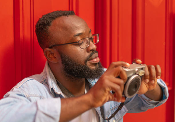 istock Young black man with photocamera 1729280826