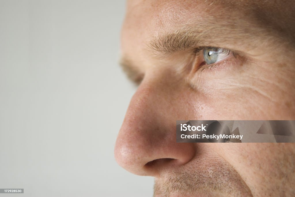 Profile Close-Up of a Man's Blue Eye and Prominent Nose Close-up shot of a man's blue eye and prominent nose Nose Stock Photo