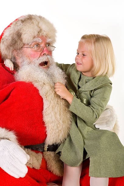 istock Cute little girl on Santa'a lap pulls his beard 172928772