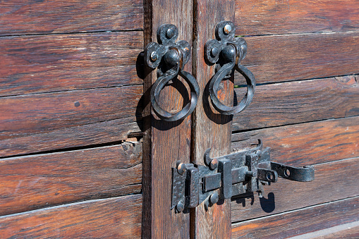 Door knocker on ancient wooden door in Tbilisi, Georgia, close up