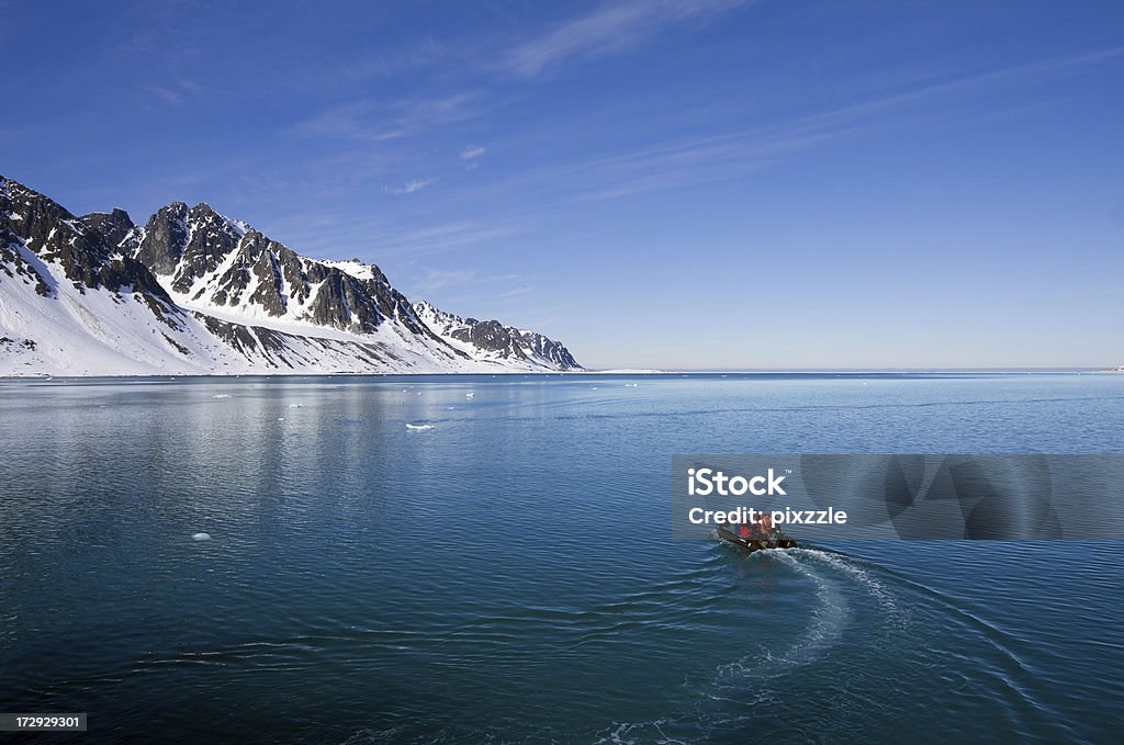 Spitsbergen Norway, Arctic boat adventure in Magdalenefjord "A small inflatable boat of adventurous tourists exploring Spitzbergen, Norway. Magdalenefjord is a bay in the Svalbard Islands at 79A North in the Arctic Ocean." Svalbard Islands Stock Photo