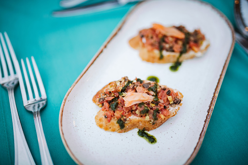 Bruschetta with salmon, tomato salza and basil pesto.