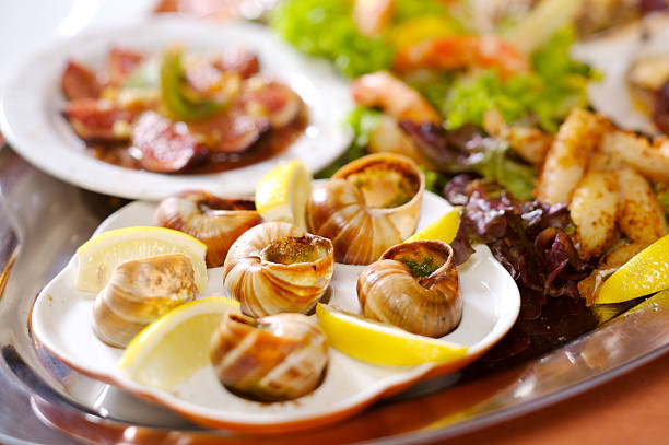 istock Escargot presented in ceramic, with butter and lemon 172930529