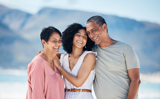 Beach, senior parents and adult daughter together with smile, love and hug on summer holiday in Mexico. Embrace, happy family support and mature mom, dad and woman on ocean holiday travel in nature.