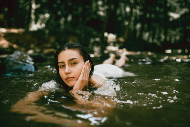 istock Female Flirting With Her Gaze While Bathing In Cold River Water 1729315990