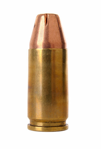 Macro shot of a 9mm hollow point bullet.  Studio Isolated on white.
