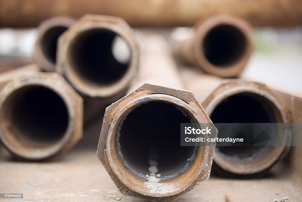 Brown rusty metal pipes Rusty metal pipes at a recycling or construction yard. Lead Stock Photo