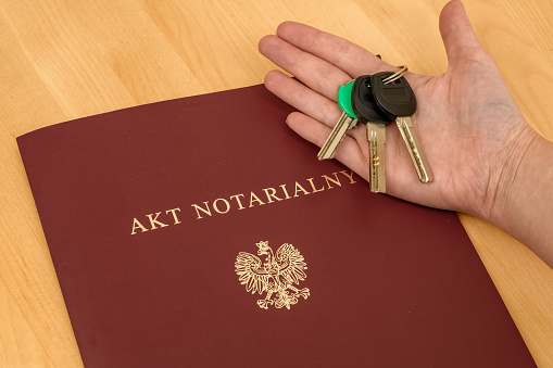 The keys to the apartment are on a Polish notarial deed, closeup