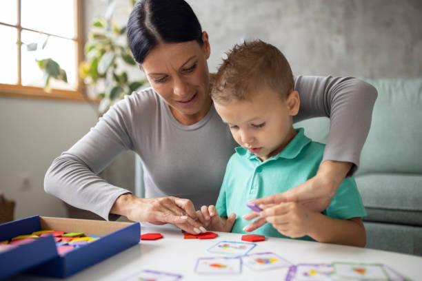 istock Boy and his babysitter playing with block toys 1729324854