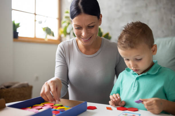 istock Boy and his babysitter playing with block toys 1729324856