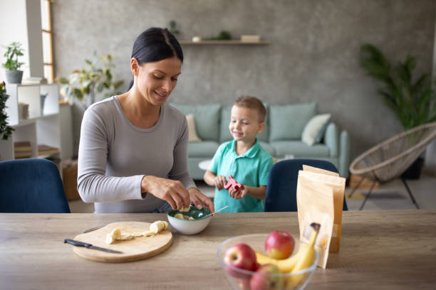 istock Babysitter preparing food for a boy that she's taking care of 1729332042