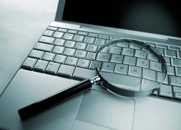 istock Magnifying Glass Resting on a Laptop 172933431