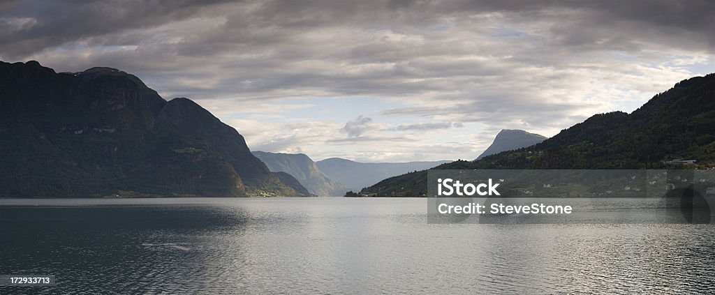 Luster Panorama Evening XXL "A calm, late evening view of the Fjord at Luster (joined to the Sognefjord). Weak sunlight just picks out a meadow while the rest of the landscape falls into shade, almost silhouetted. This is a stitched panorama. Adobe RGB 1998 profile." Norway Stock Photo