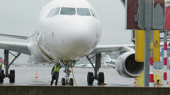 Airplane is preparing for departure at the airport during rain.