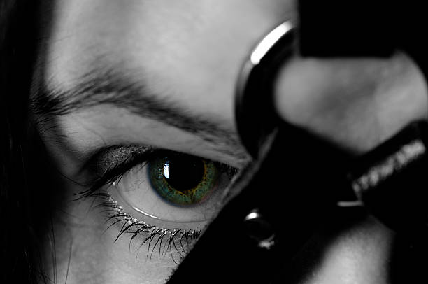 Harness A woman wearing a fetish harness. Focus on her eye. Desaturated apart from the iris. Tied Up Bondage Women Fetish Wear stock pictures, royalty-free photos & images