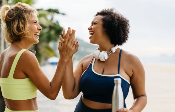 istock Fitness friends celebrating with a high five after a beach workout session 1729342225