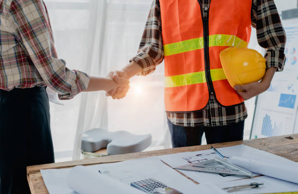istock Engineers, designers and interior designers are handshake shack hands deal finalizing the design of interiors by discussing selecting materials and colors to design rooms to present to clients. 1729350135