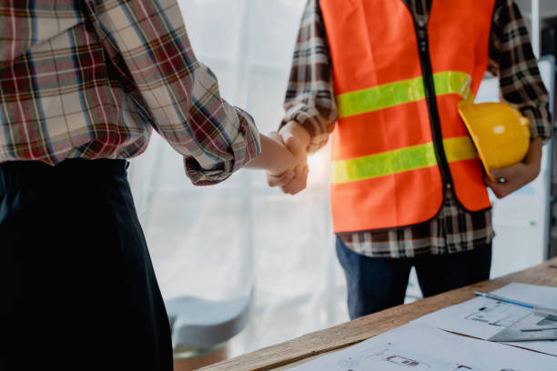 istock Engineers, designers and interior designers are handshake shack hands deal finalizing the design of interiors by discussing selecting materials and colors to design rooms to present to clients. 1729350663