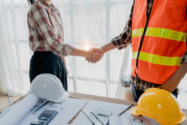 istock Engineers, designers and interior designers are handshake shack hands deal finalizing the design of interiors by discussing selecting materials and colors to design rooms to present to clients. 1729350681