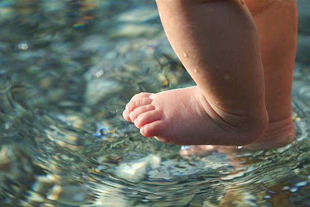 baby feet above the sea stock photo