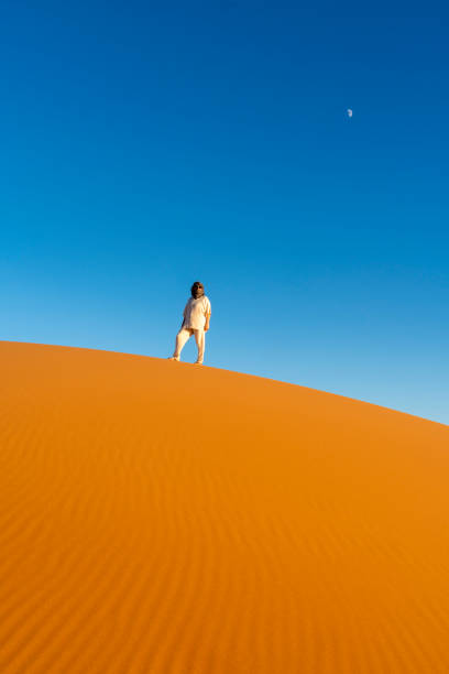 Mature woman in Western Sahara Desert, Morocco. Woman adventuring out in the desert.