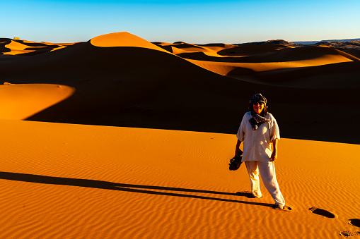 Mature woman in Western Sahara Desert, Morocco. Woman adventuring out in the desert.