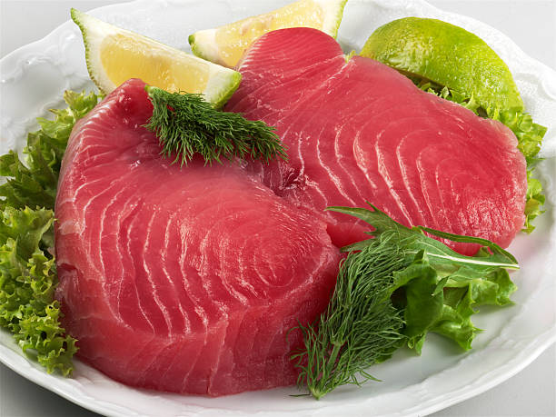 Fresh raw tuna steaks on white background